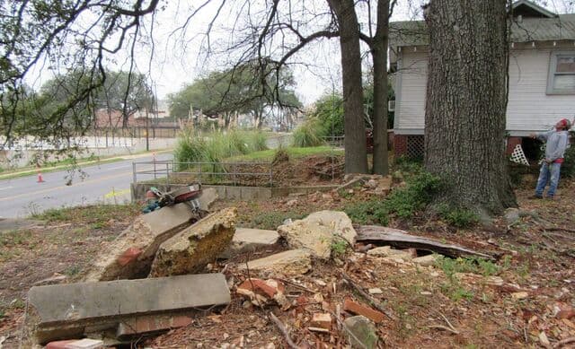 Broken concrete slabs and brick from an old foundation, ready to be removed