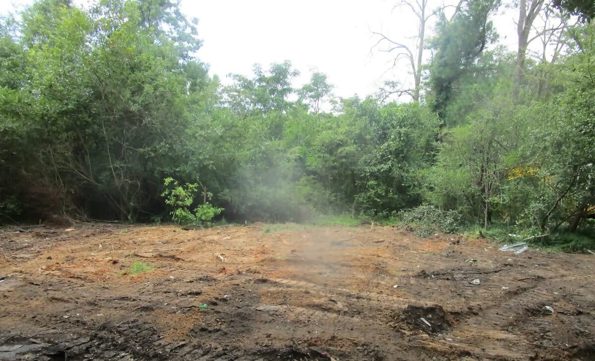 The same wooded lot scraped clean after the debris was removed