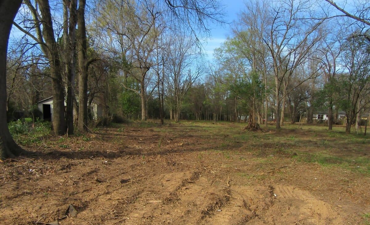 Graded dirt with equipment tracks after land clearing